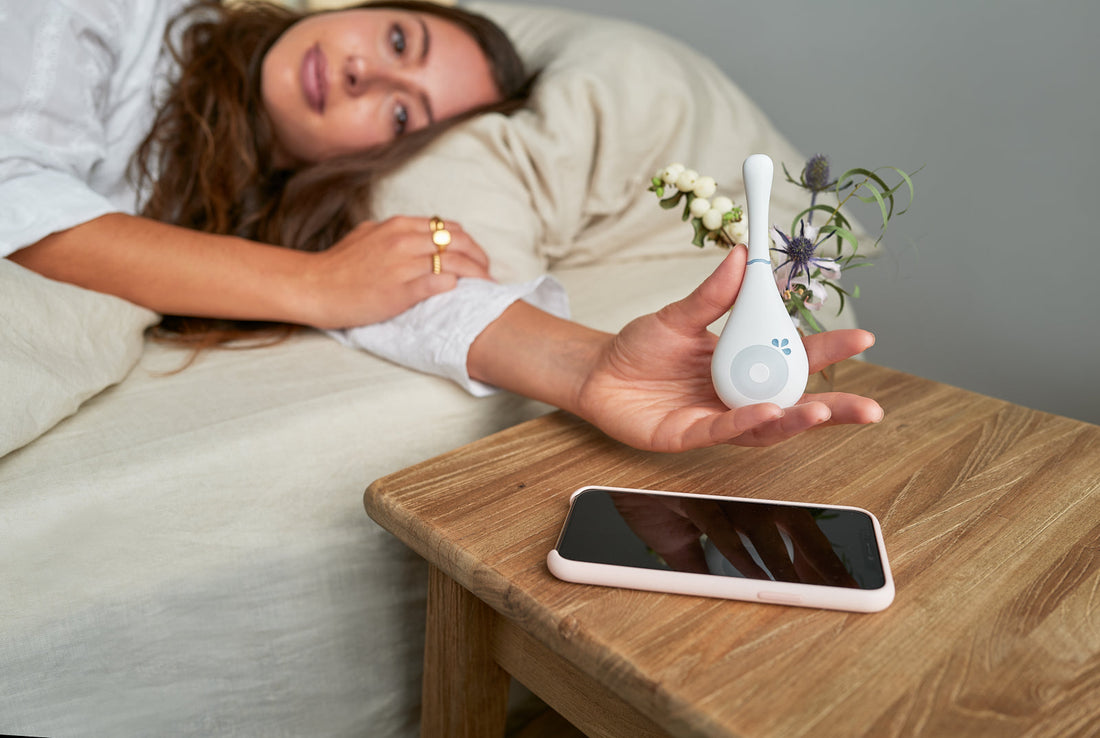 Woman journaling her menstrual cycle data in a calm, sunlit space, representing period tracking and fertility awareness