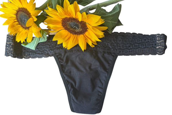Black thong with sunflower decorations on a white background
