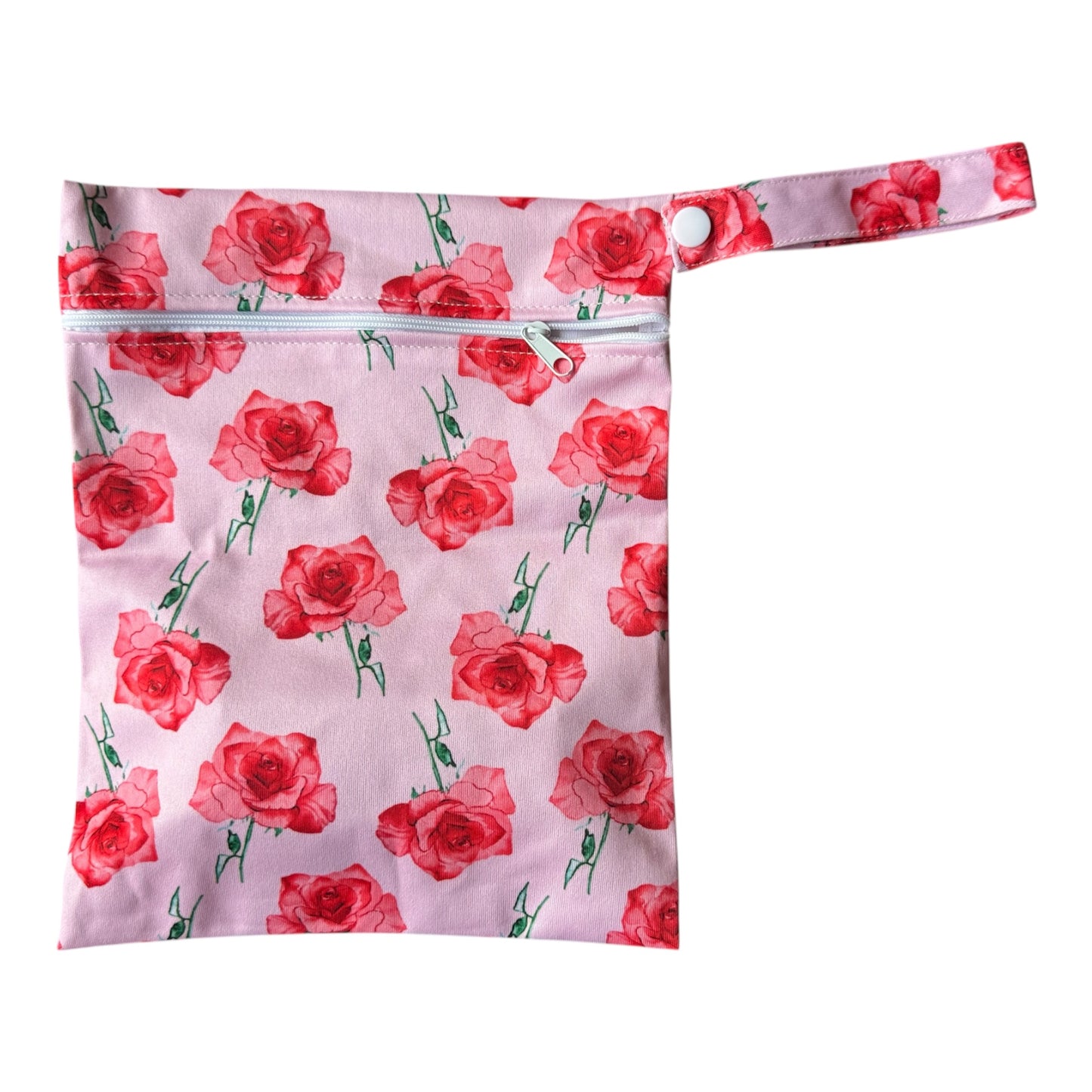 Floral-patterned pouch with red roses on a pink background